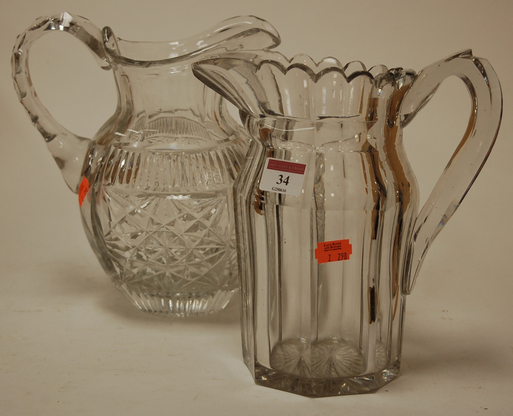 A late 19th century cut glass water jug together with one other (2)