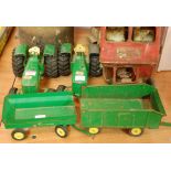 A Ertl green painted model of a John Deere tractor together with trailer,