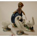 A Lladro figure of a girl with geese together with two other singular geese figures (3)