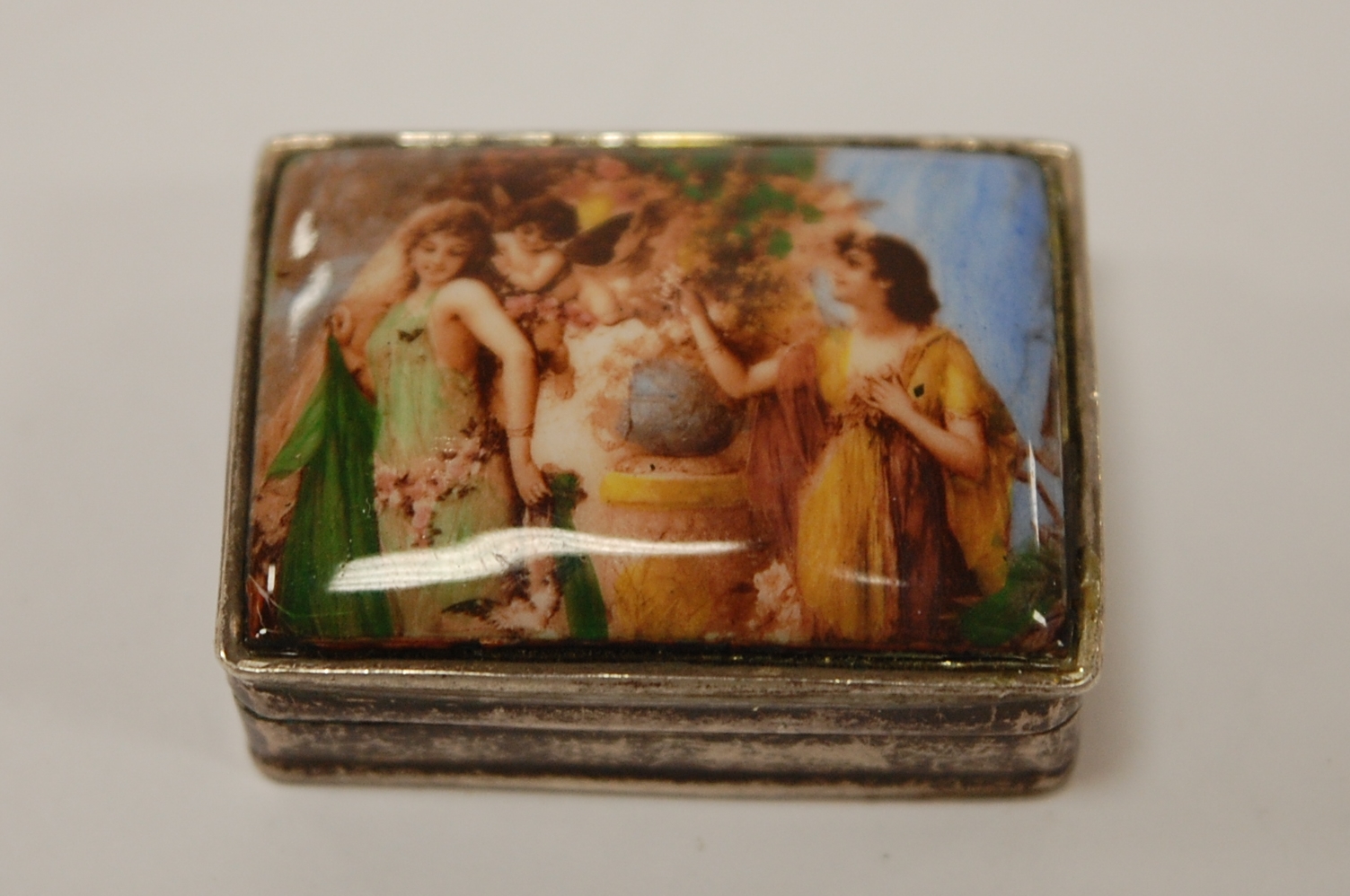 A reproduction silver and porcelain topped pillbox