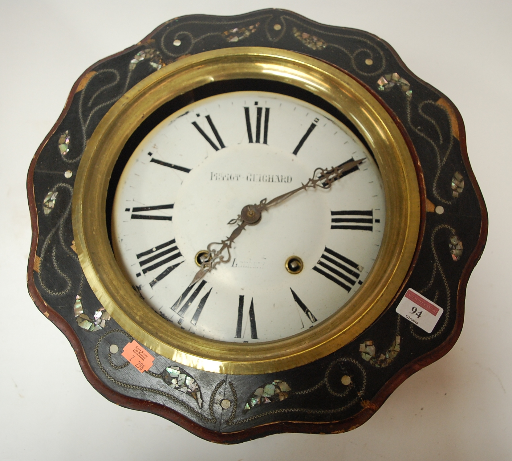 A late 19th century French wall clock having an enamel dial with Roman numerals housed in an