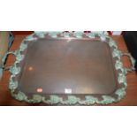 A large Victorian copper tray having a scrolling silver plated twin handled border