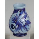 A modern Moorcroft blue-on-blue miniature squat vase, of lower bulbous form,