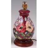 A modern Moorcroft pottery table lamp, in the Pansies on Maroon pattern,
