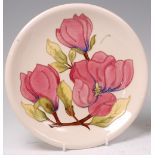 A modern Moorcroft pottery charger, in the Hibiscus pattern,