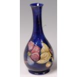 A Moorcroft pottery bottle vase, in the Anemone pattern, underglaze painted on tones of blue,