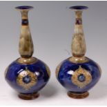 A large pair of Royal Doulton stoneware bottle vases, decorated by Maud Bowden,