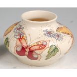 A modern Moorcroft pottery squat vase in the Butterfly pattern, of mid-bulbous form,