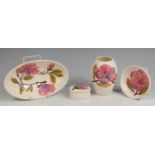 A collection of Moorcroft magnolia pattern pottery, to include; an oval bowl, length 23.