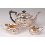 An Edwardian silver three piece tea set, comprising; teapot, twin handled sugar and cream,