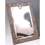 A late Victorian silver embossed easel dressing table mirror, of good size,
