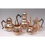 An Edwardian silver four piece tea and coffee service together with a near-matching hot water pot,