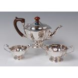 A silver three piece teaset, comprising pedestal teapot, twin handled sugar and cream,