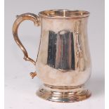 A George III silver bell shaped christening tankard, having leaf capped flying S scroll handle,