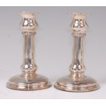 A pair of George V silver column candlesticks, on circular loaded bases, makers mark worn,