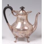 An Edwardian silver teapot, of pear shape, having hinged dome cover, ebony handle,