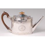 A George III silver teapot, of oval form, with engraved banded decoration and walnut handle, 12.