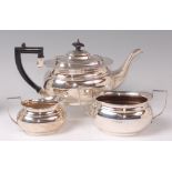 A George V silver three piece teaset, comprising; teapot, twin handled sugar and cream,