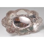 A late Victorian silver sweetmeat dish, of pierced and shaped oval form,