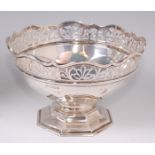 An Edwardian silver pedestal bowl, having a shaped and pierced rim to an octagonal footed base, 11.