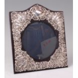 A Victorian style silver and embossed mounted easel photograph frame,