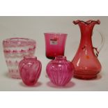 A small collection of glassware to include cranberry glass beaker, two Monart style glass vases,