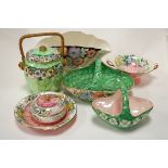 A Maling lustreware boat shaped vase decorated with flowers, together with biscuit barrel and cover,
