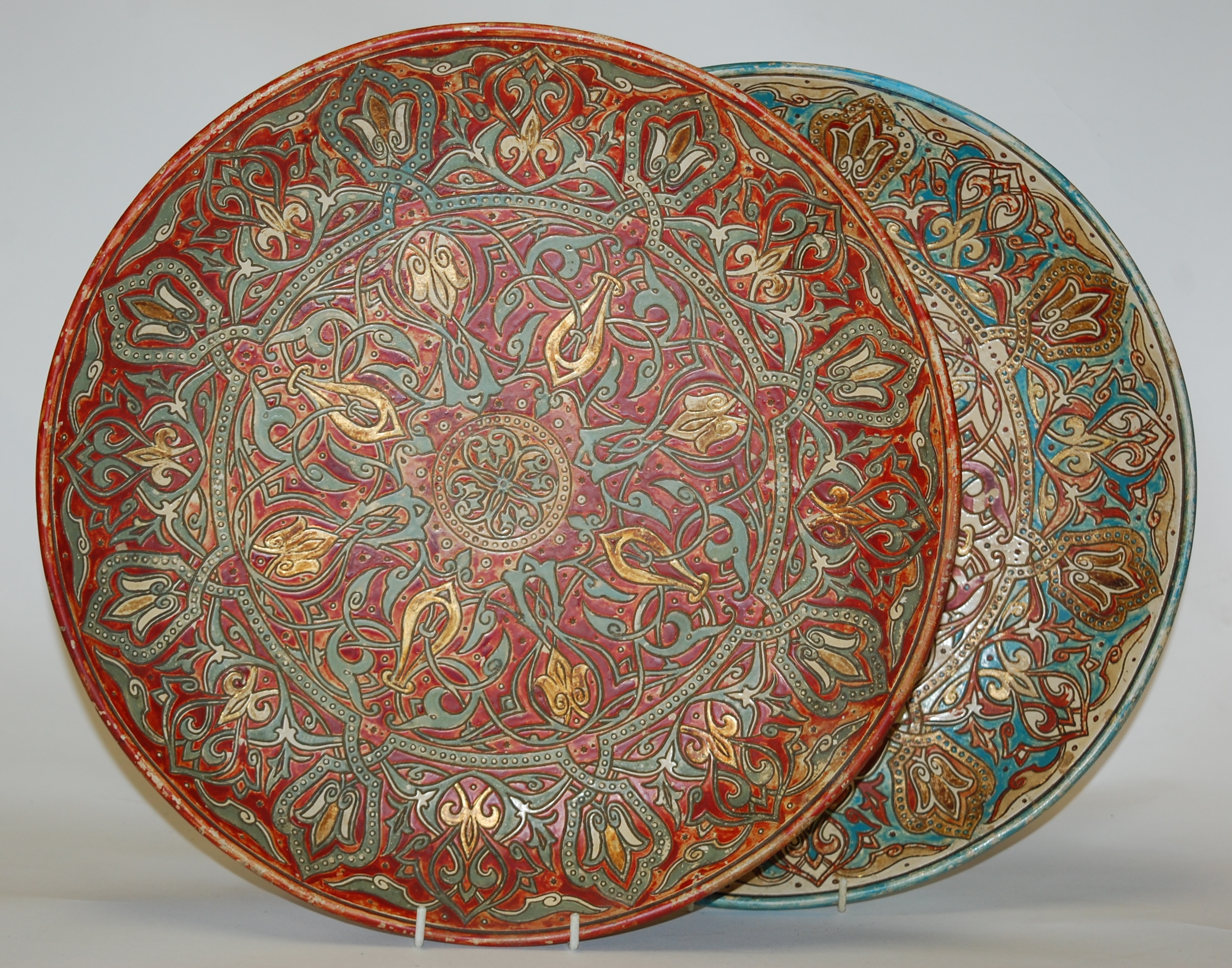 A pair of Watcombe pottery chargers, each with all-over sgraffito decoration, incised 6925 verso,