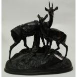 A Kanch cast iron figure of deer on naturalistic base with foundry mark verso