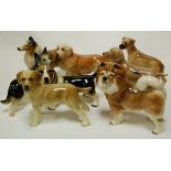 A collection of assorted ceramic dog figures to include Coopercraft examples