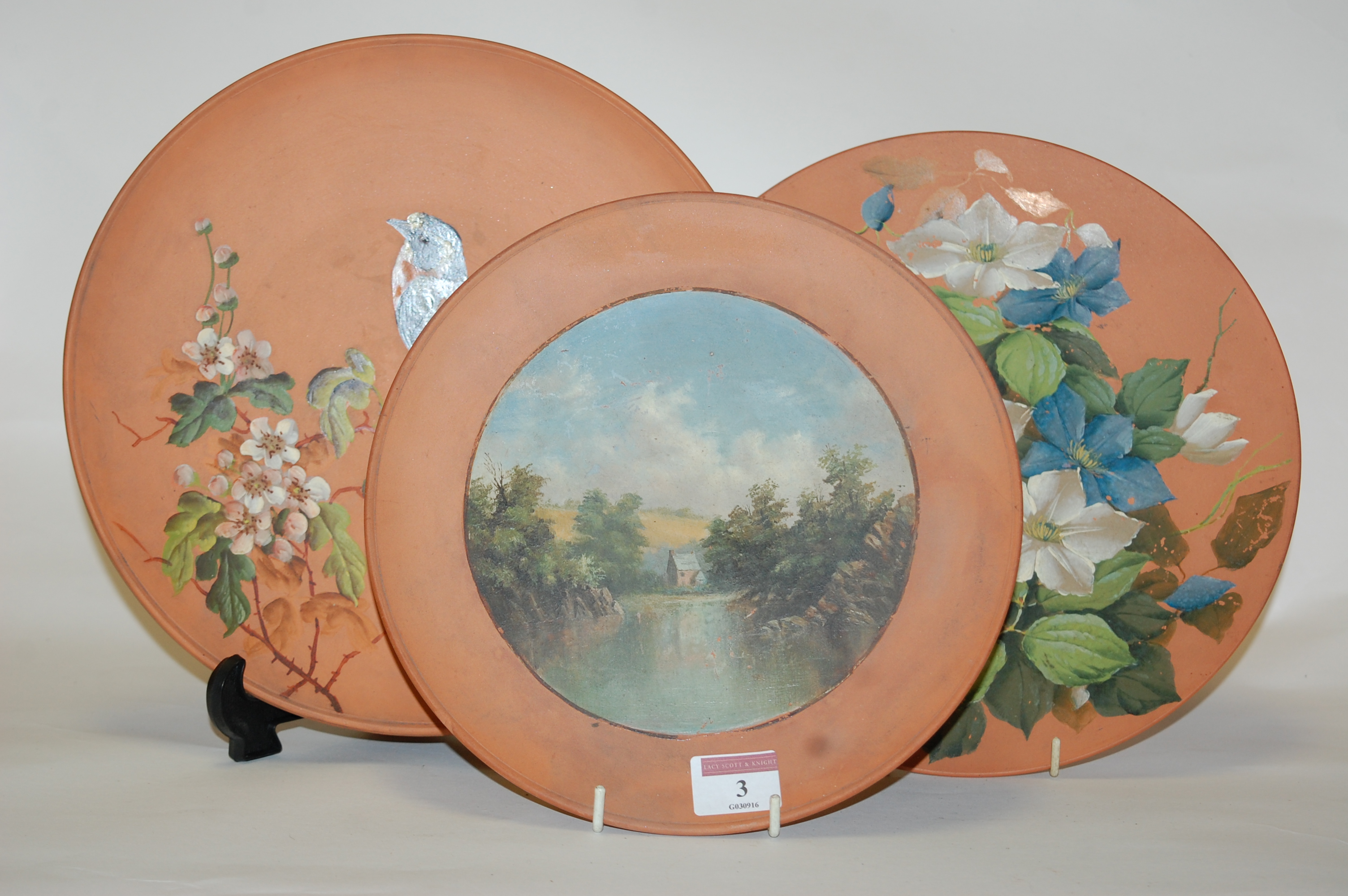 A Watcombe pottery plate, hand-painted with a cottage landscape,