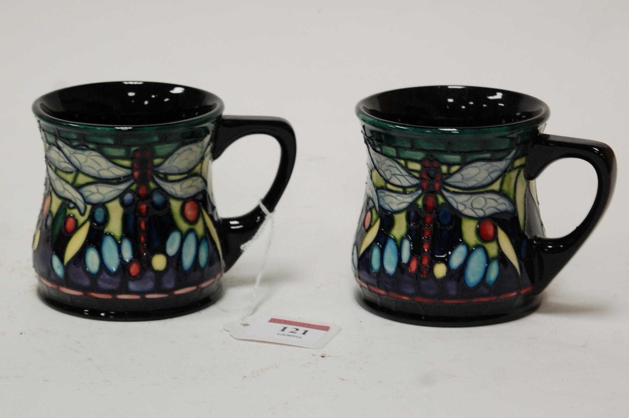 A pair of modern Moorcroft mugs in the Dragonfly pattern, impressed mark verso dated 2000, height 8.