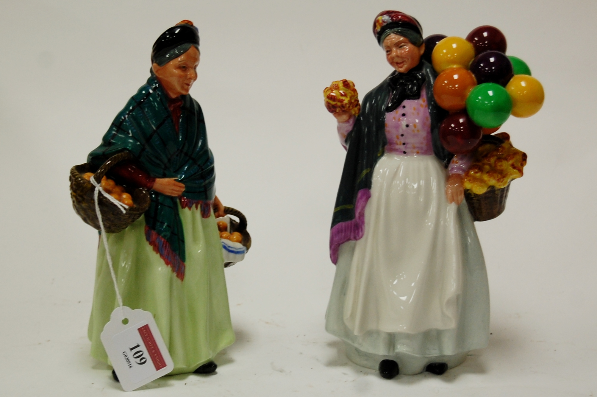 A Royal Doulton figure of The Orange Lady HN1953 together with one other Biddy Penny Farthing