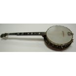 A Remo Weather-king four string banjo, the ebonised neck with mother-of-pearl inlay,