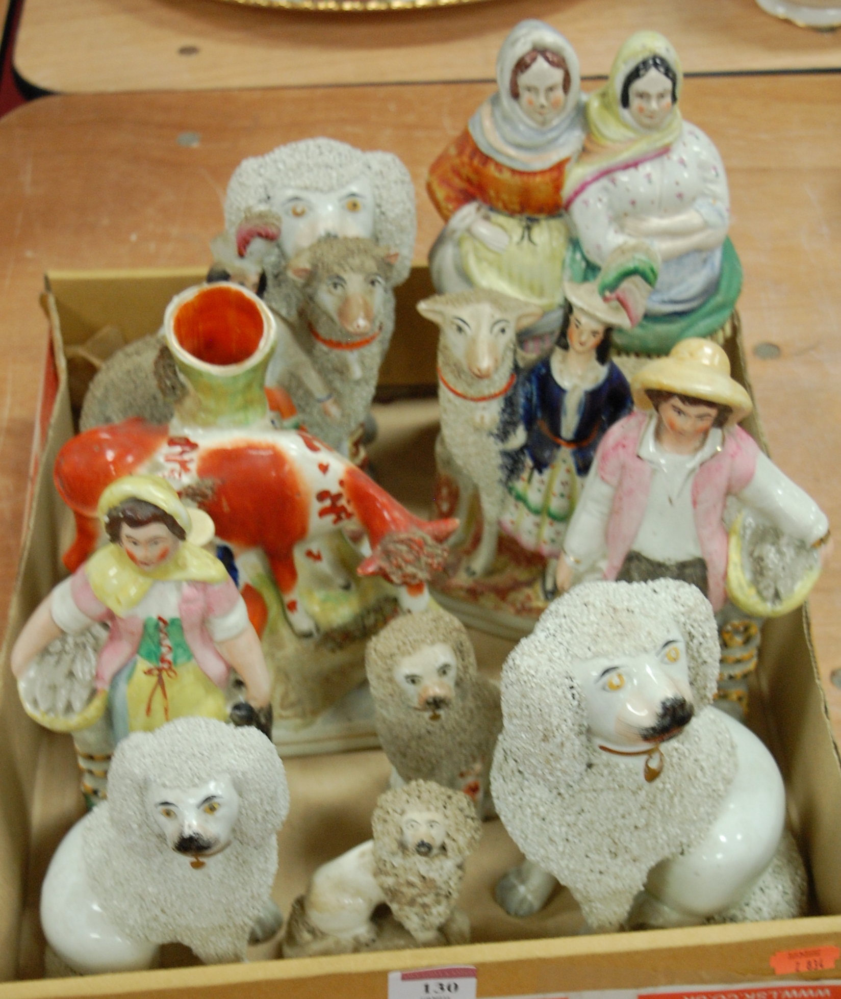 A collection of assorted Victorian and later Staffordshire figures to include seated poodles,