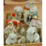 A collection of assorted Victorian and later Staffordshire figures to include seated poodles,