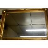 A reproduction gilt framed and bevelled wall mirror,