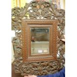 A bevelled wall mirror in Far Eastern carved teak surround, h.