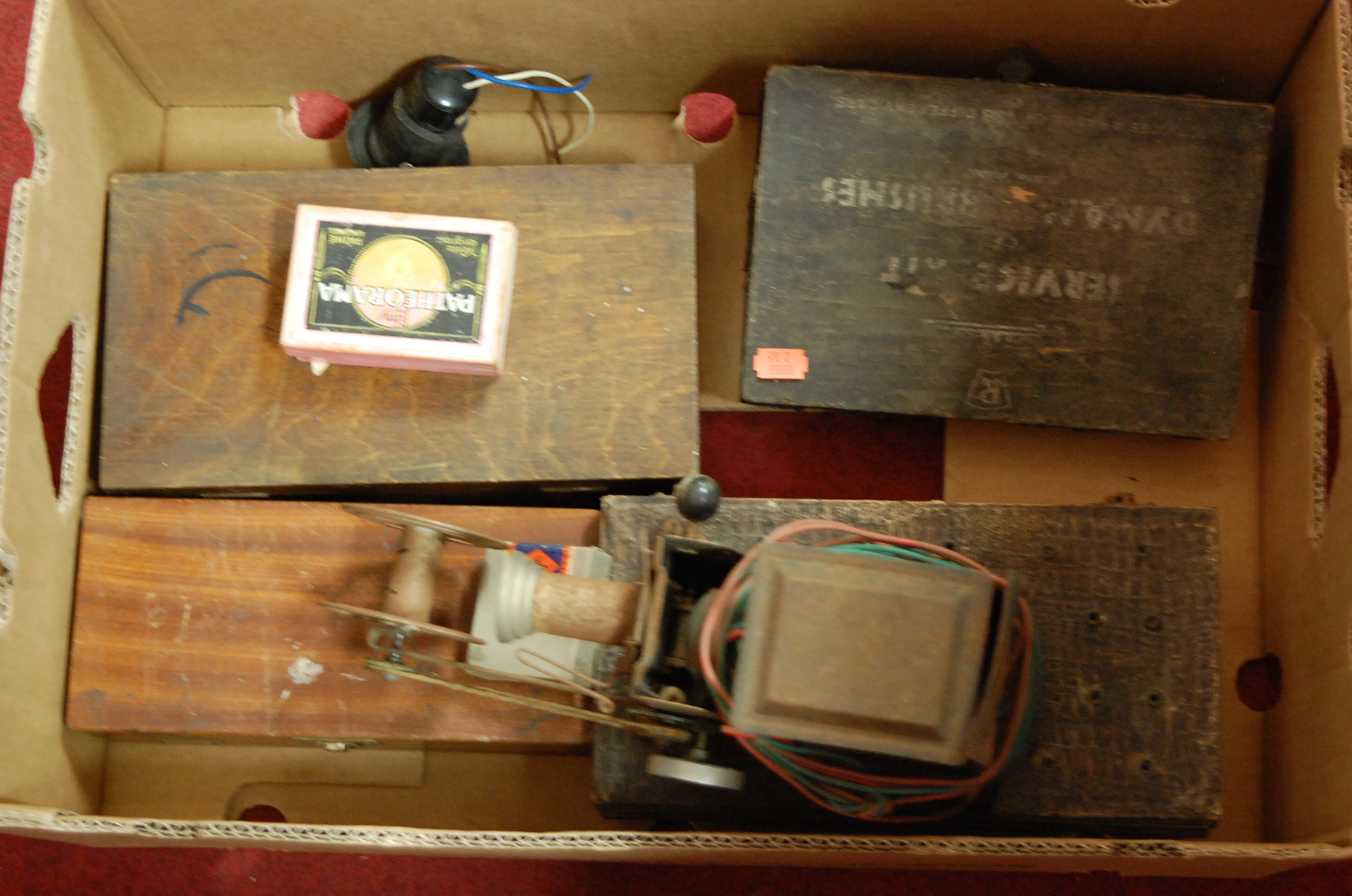 A box of miscellaneous items to include; early tinplate cine-camera,