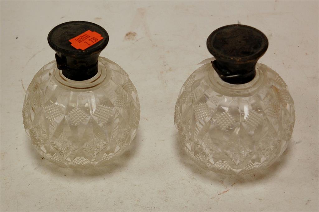 An Edwardian cut glass and silver mounted scent bottle together with one other similar example (2)