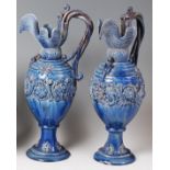 A pair of Edward Bingham Castle Hedingham pottery pedestal ewers,