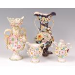 An English porcelain floral encrusted pedestal vase, probably Coalport, having a blue ground,