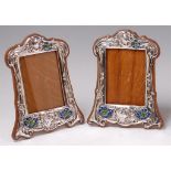 A pair of Art Nouveau silver and enamel photograph frames,