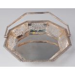 A George V silver fruit / cake basket, of octagonal form, having pierced rim, and on scroll feet,