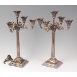 A pair of late 19th century silver plated five light candelabra, having beaded detachable sconces,