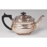 A Maple & Co silver teapot, of oval bombe form, having ebony handle and raised on ball feet,