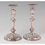 A pair of early Georgian silver candlesticks, each having detachable petal sconces, knopped stems,