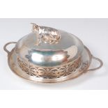 A late Victorian silver butter dish, the domed cover surmounted with a recumbent cow,