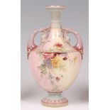 A late 19th century Royal Worcester porcelain pedestal vase, of twin handled urn shape,