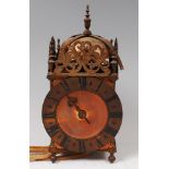 A Victorian brass lantern clock, in the 17th century style, having a bell top, pierced brass frieze,